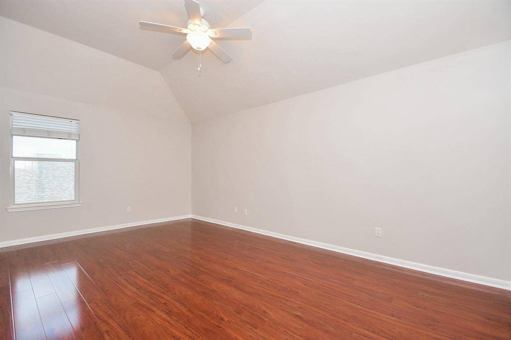 The second upstairs bedroom has a window for natural light and has a walk-in closet.