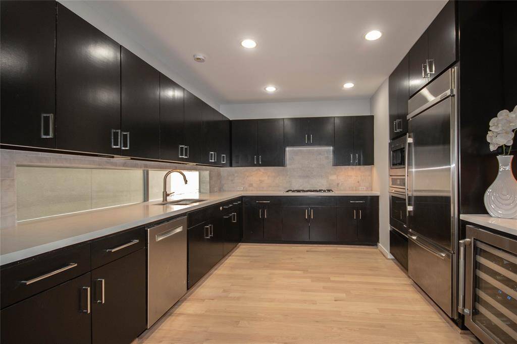 Modern kitchen with new Quartz countertops and some Jenn air stainless steel appliances, Under cabinet lighting gives it a stunning look!