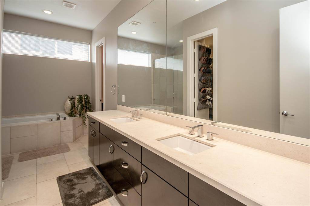 Sleek Primary bath that says executive every where including nice walk in closet