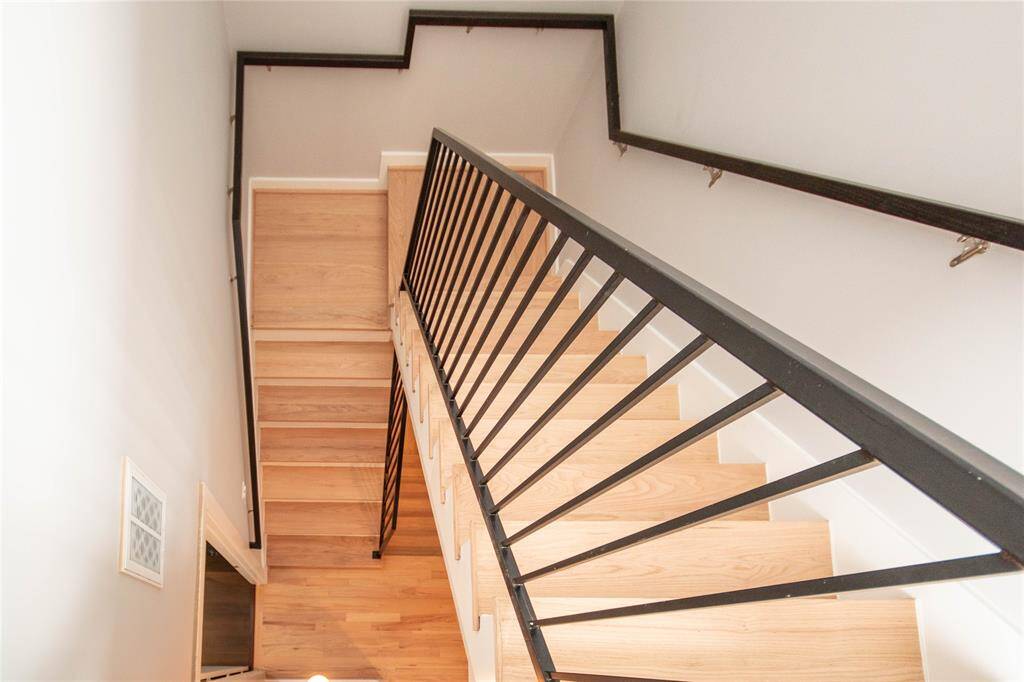This picture was taken and new hardwood floors are foyer and stairwell and door below takes you into second bedroom.  This picture was taken from fifth floor.