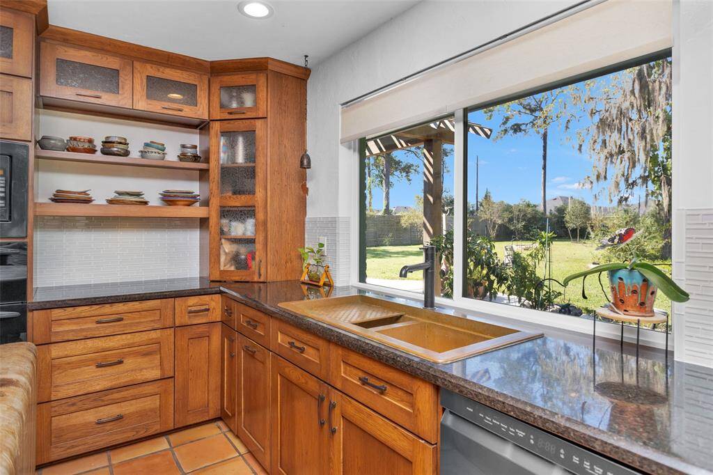 The view of the backyard makes handwashing those special dishes in the oversized double copper sink much more enjoyable. Don't worry there is a dishwasher!