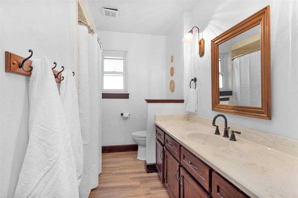 The secondary bathroom is situated between the two additional bedrooms and offers ample countertop and cabinet space.