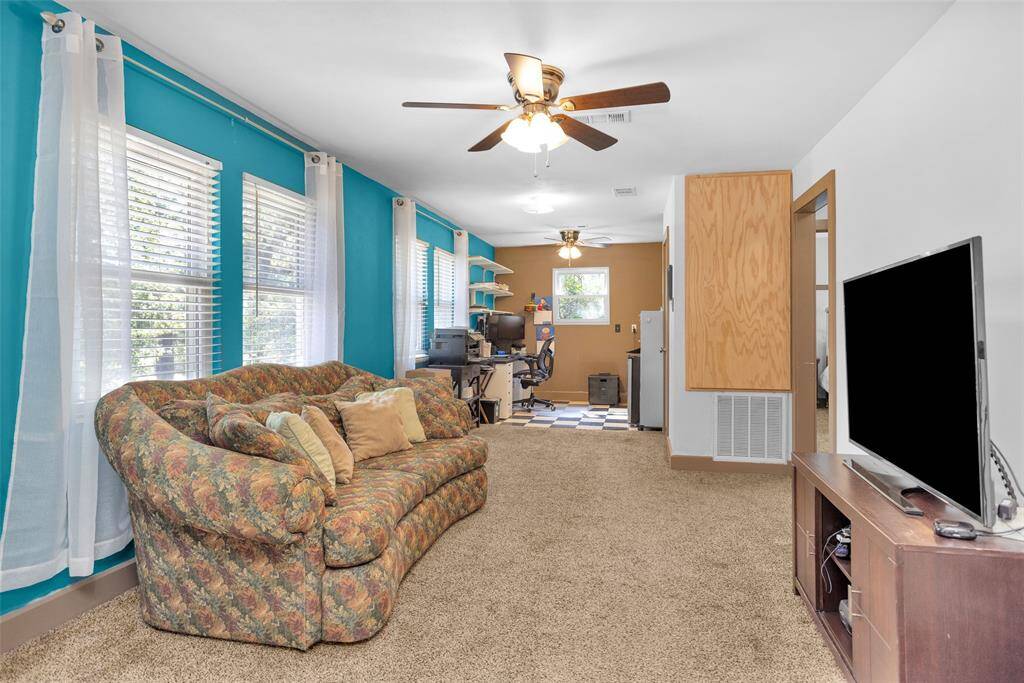 The game room and office space above the garage feature windows that let in plenty of natural light.