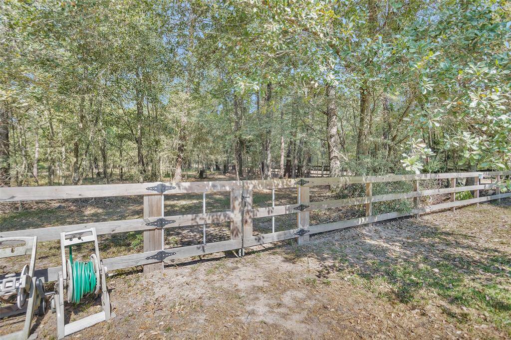 The double gate leads to the wooded 2.73 acres.