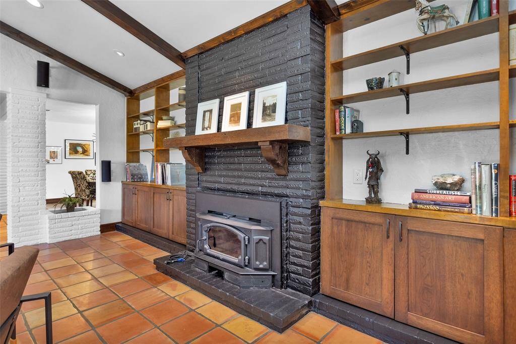 Custom Amish cabinets frame the fireplace, offering plenty of space for books or showing off family heirlooms and artwork.
