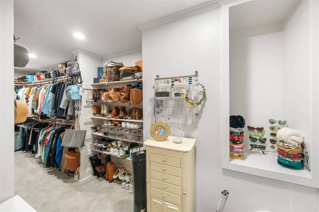 Dual closets located in between the Bathroom and Bedroom areas in the Primary Suite.  This is the larger of the two.