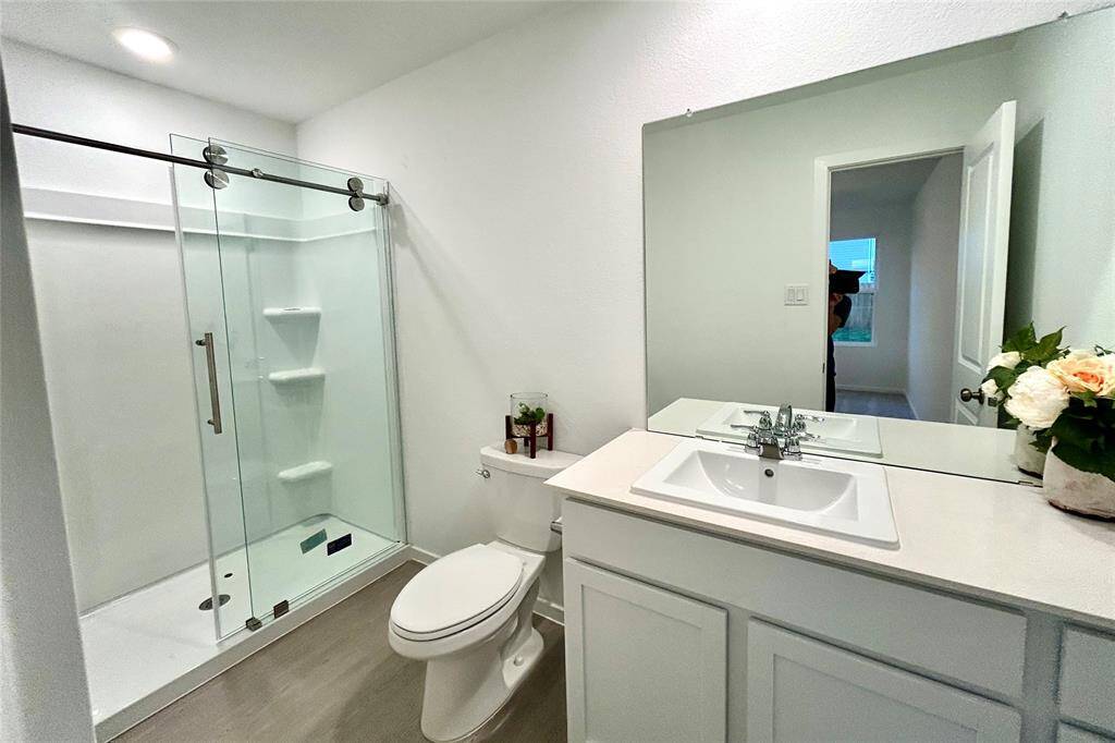 Modern shower door installed for primary bathroom