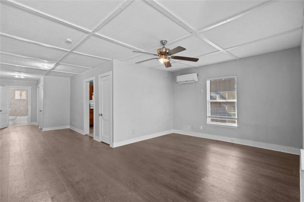 Main living area with peaceful, neutral paint, ceilings fan, and laminate wood flooing