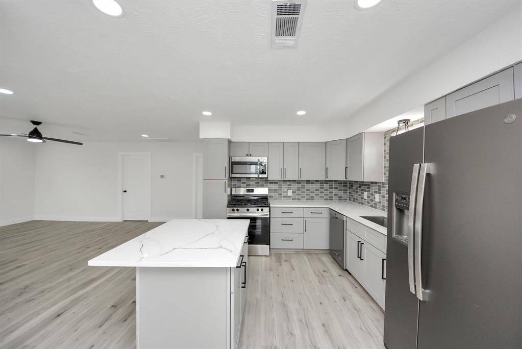 Gorgeous quartz countertops and designer backsplash.