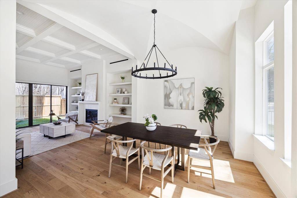 Unique Aesthetic - This dining room features an eye-catching groin vaulted ceiling, a six-candle black metal chandelier that lights up this extraordinary space. Designed for an oversized dining table with abundant space and easy circulation seamlessly blending aesthetics with functionality.