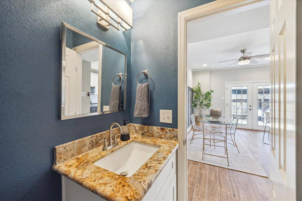 This sweet powder bath painted with the most perfect moody blue shade is right next to the coffee/wine bar.