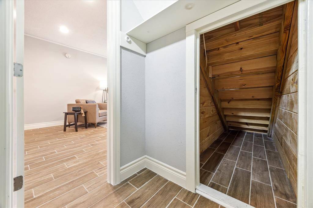 Hidden the heart of the living space is a huge walk-in closet with built-in climate controlled picture and holiday storage under the stairs - no more fear of melted candles and glued together photos!
