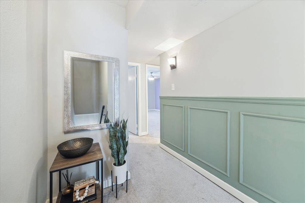 The upstairs hall has also received decorative treatment and updated satin nickel light fixtures.