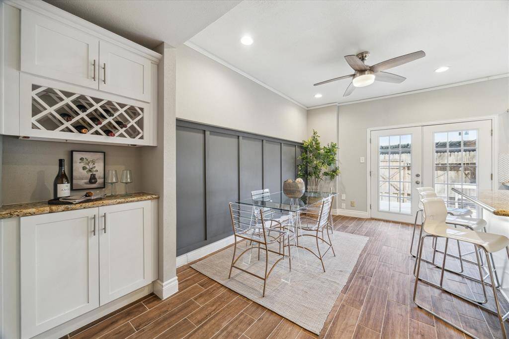 Love this bright kitchen and breakfast area with board and batten wall treatment, art ledge and separate wine or or coffee bar with built-in storage.