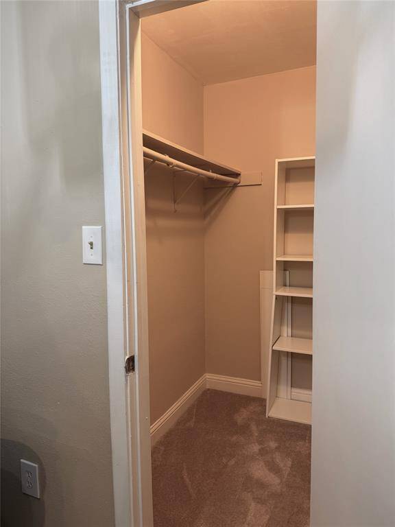 Primary bedroom walk-in closet