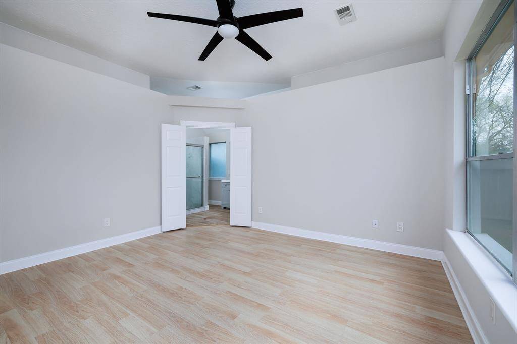 Primary bedroom with ensuite bathroom and giant walk in closet.