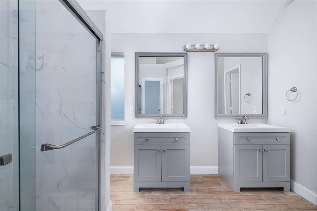 Recently remodeled bathroom with dual vanities, large walk in shower and walk in closet.