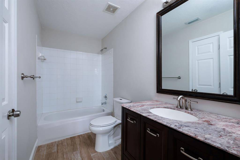 Secondary bathroom located down the hall from both secondary bedrooms.