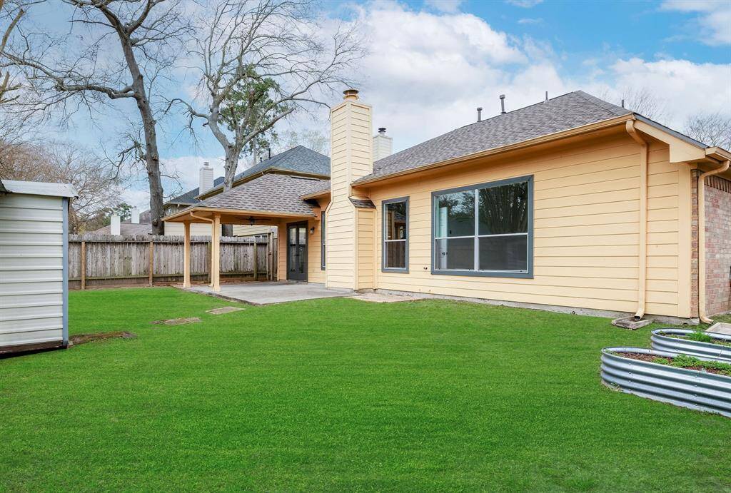 The backyard is beautiful in Spring and Summer. Storage Shed and garden beds stay!