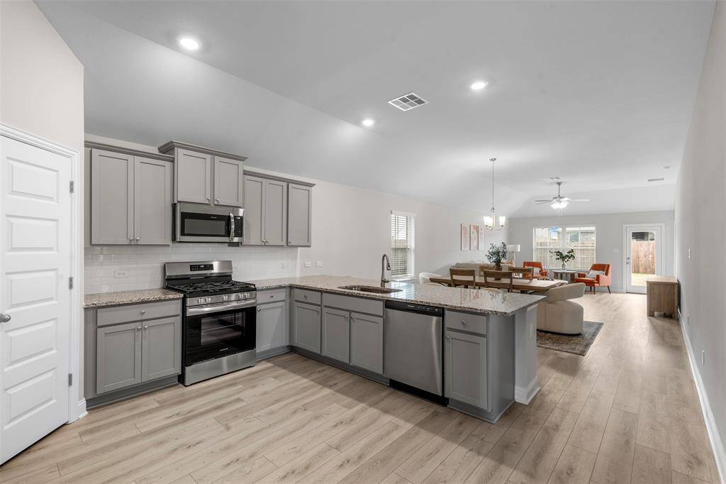 The kitchen is open to the dining and living areas