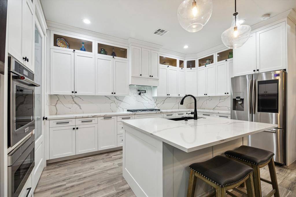 Stunning white custom cabinetry and a nature-inspired neutral palette make for a peaceful space for morning coffee.