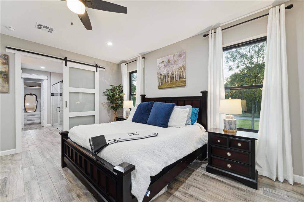 This primary suite peeks out to your private acreage.