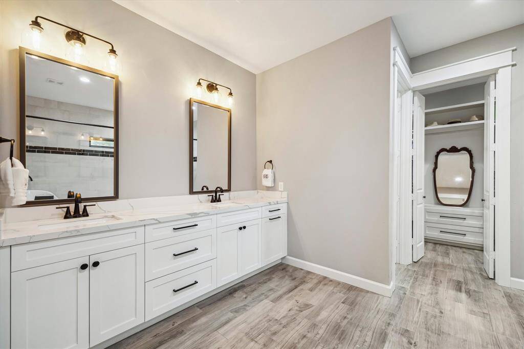Sleek modern features with dual sinks and expansive quartz counters provide ample space for getting ready in the morning.