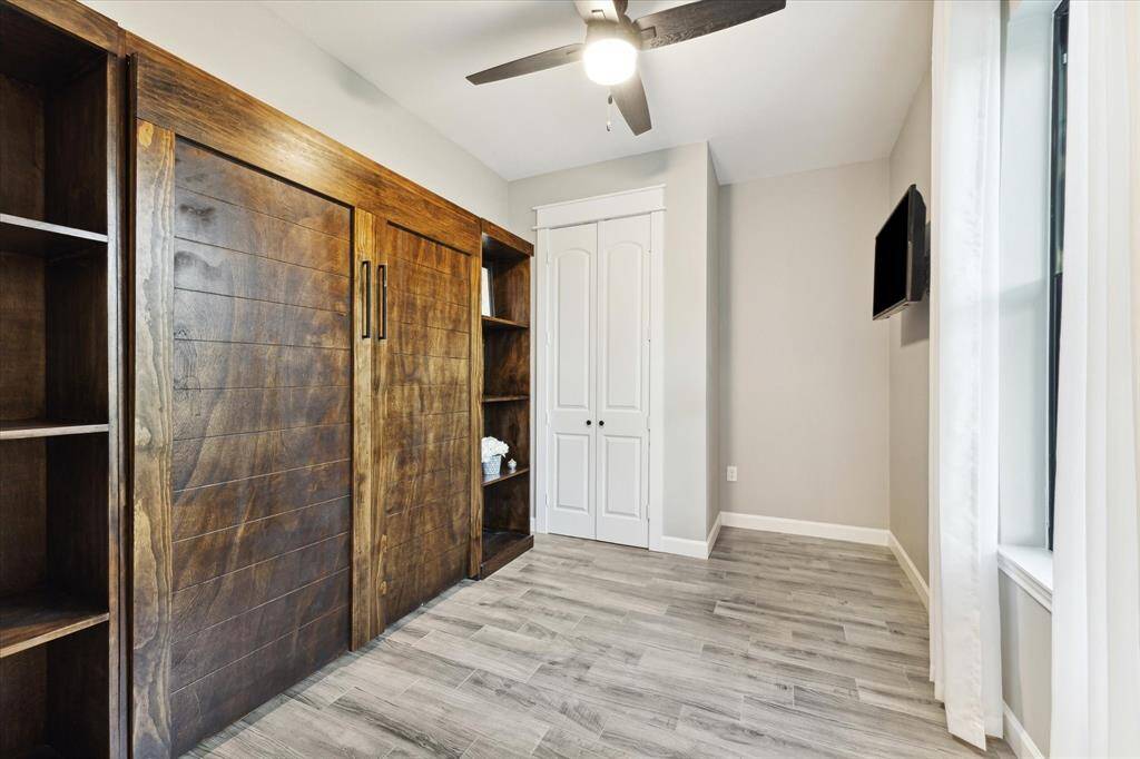 Third bedroom provides extra space with a Murphy bed. All bedrooms feature ceiling fans.