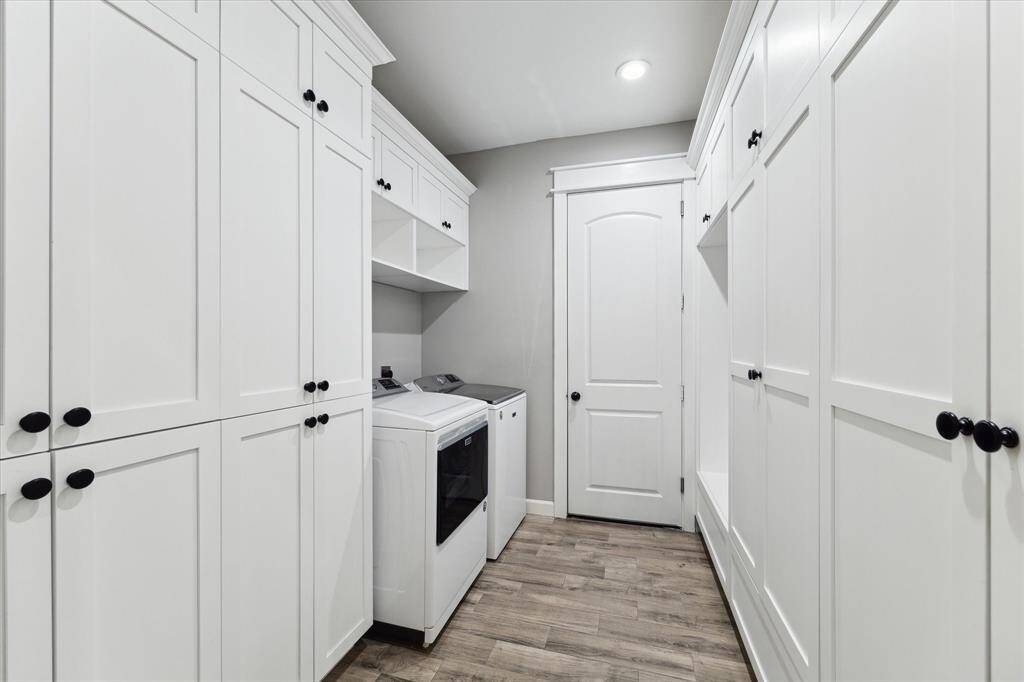 This utility room, situated just off the garage, is an ideal landing space with bench seating and storage cabinets. This beautiful laundry space might actually make laundry day enjoyable!