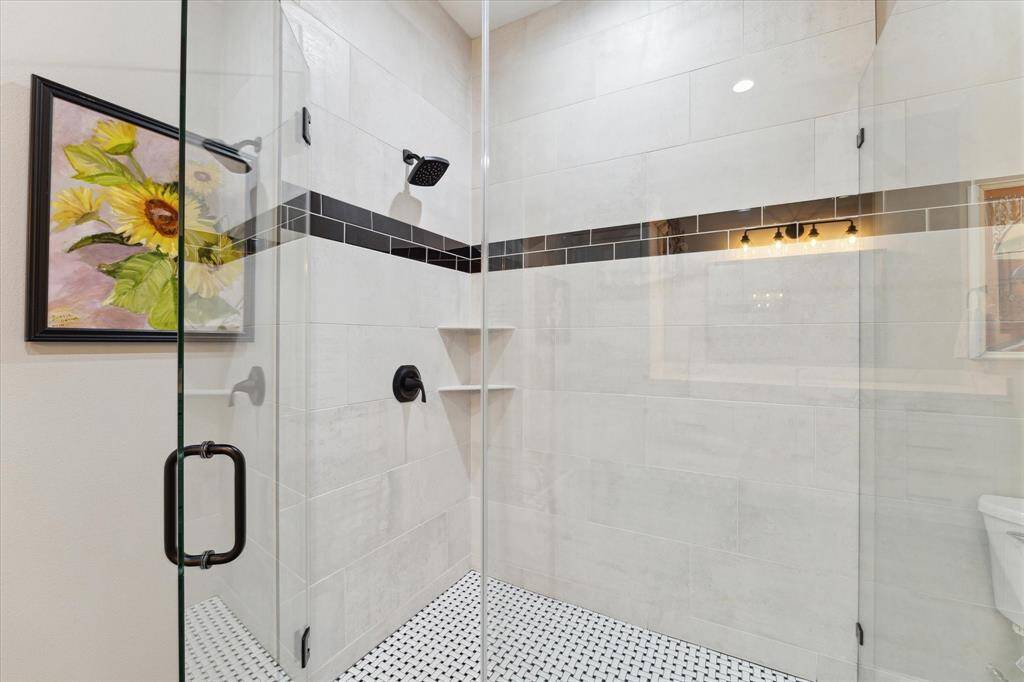A luxurious shower promises a spa-like experience, with high-end fixtures, ample space.