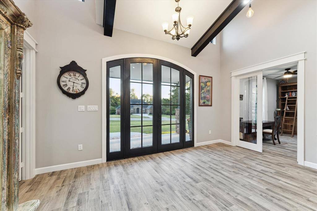 Stunning custom nine foot glass double-doors create a light-filled airy entry.