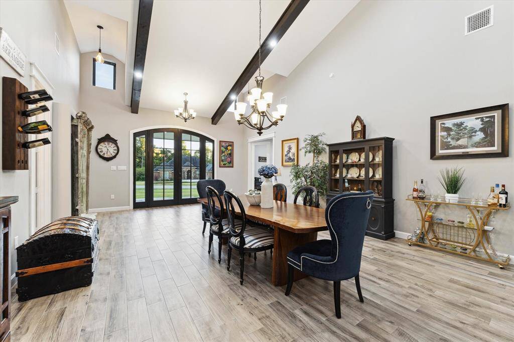 Expansive dining room is ready for all of your holiday gatherings. In addition to the chandelier, wood beams house energy efficient LED lighting.