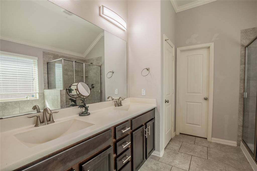Large vanity with double sinks and updated lighting in Primary Bath