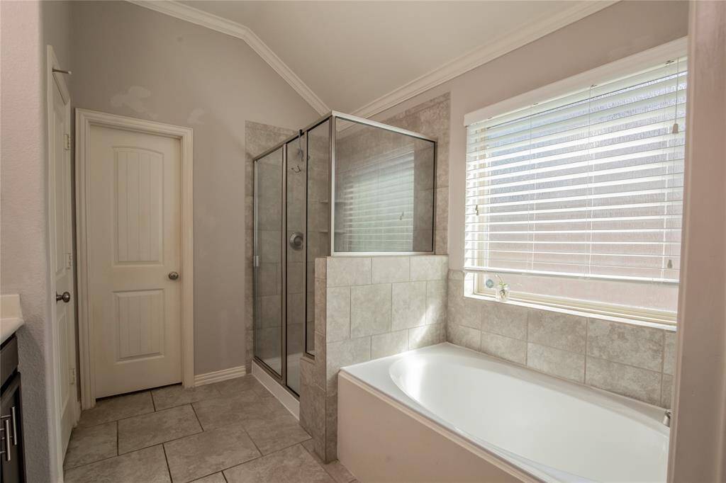 Soaking tub and separate shower with built-in bench in Primary Bath
