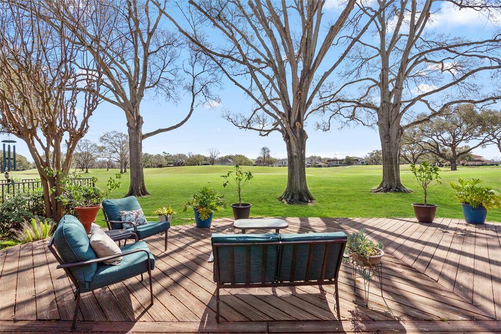 This expansive backyard deck offers breathtaking views of the golf course, providing a tranquil retreat with lush greenery and mature trees. The open design allows for seamless indoor-outdoor living, while the wooden deck enhances the natural beauty of the surroundings. A perfect space to unwind, entertain, or simply enjoy the picturesque scenery.