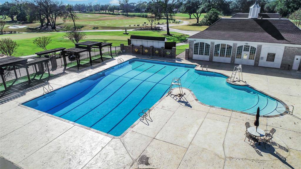 Enjoy resort-style relaxation at the Sugar Creek Country Club’s sparkling swimming pool. Perfect for unwinding or staying active, this spacious pool area features ample deck space, pergola-shaded seating, and scenic golf course views. Whether you're swimming laps, lounging in the sun, or gathering with friends, this inviting amenity enhances the luxury lifestyle of Sugar Creek living.