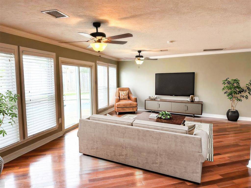 Large downstairs family room with nice view of the pool area (virtually staged).