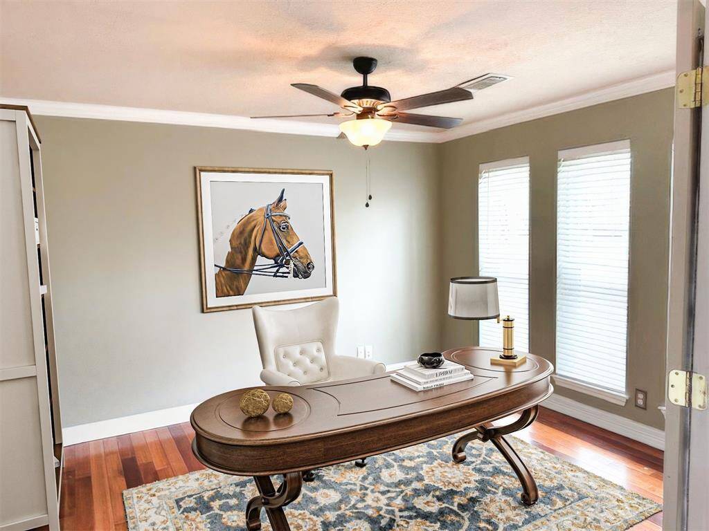 Study with double doors leading off foyer (virtually staged).