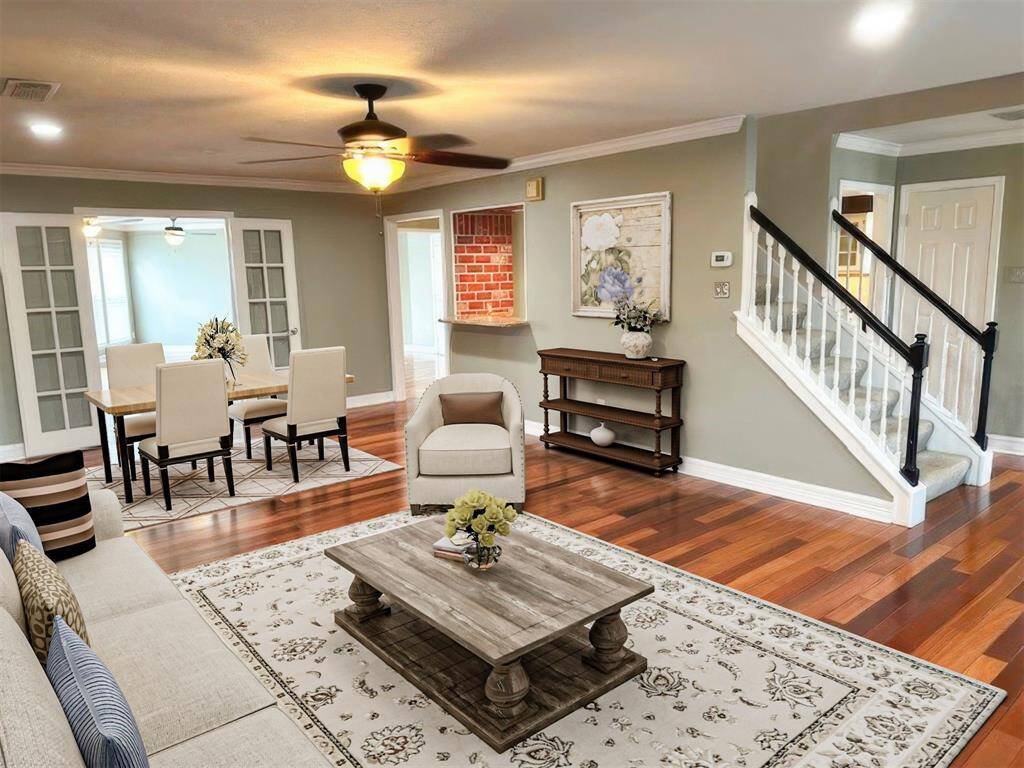 Formal Living/Dining with gorgeous hardwood flooring, fireplace and access to wet bar (virtually staged).