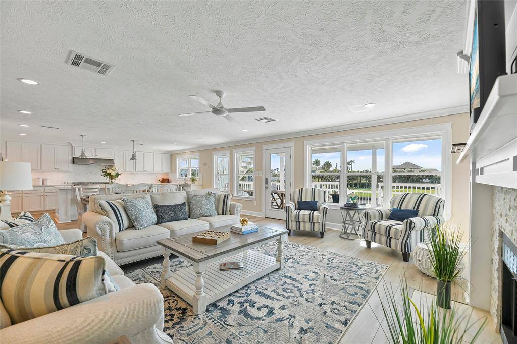 The main level of the home offers luxury vinyl plank flooring, recessed lighting, crown molding & a wall of windows.