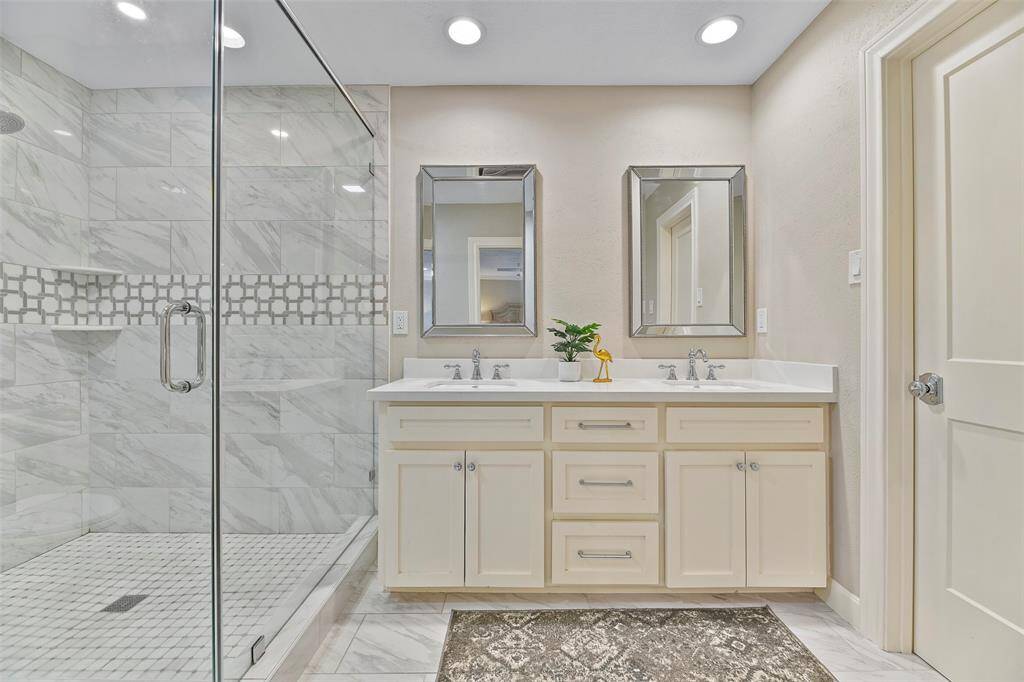 The primary bathroom features a double sink quartz top vanity, walk-in closet & large shower.