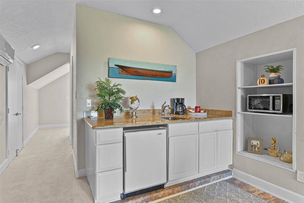 On the other side of the room you will find a kitchenette with sink, mini-fridge, coffee maker & microwave