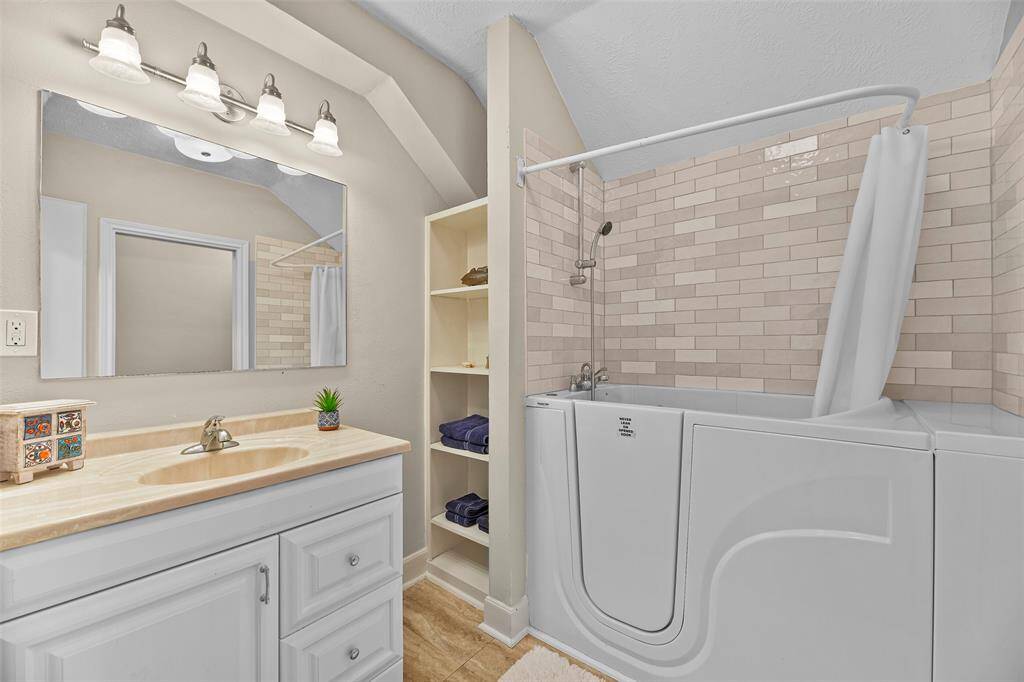 Down the hall from the kitchenette is the full-size bathroom with an easy entry shower & built-in shelving for your linens.