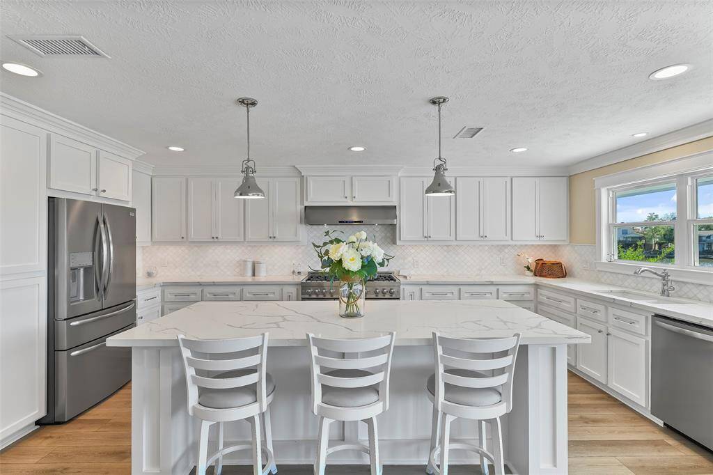 The updated kitchen is breathtaking. The Island features a breakfast bar with industrial pendant lighting.