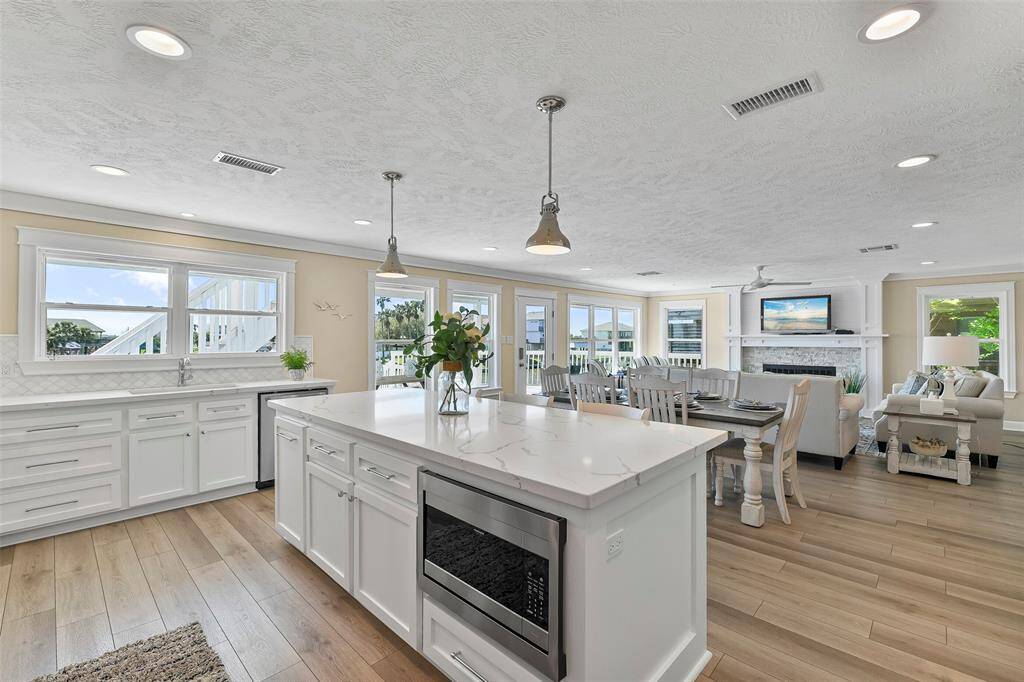On the other side of the island you will find the microwave, storage & trash can cabinet.