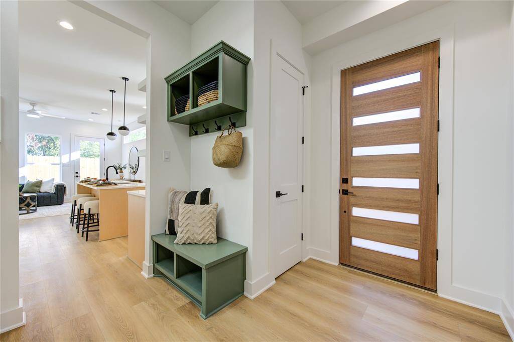 Spacious foyer features a mud bench and coat closet for extra storage