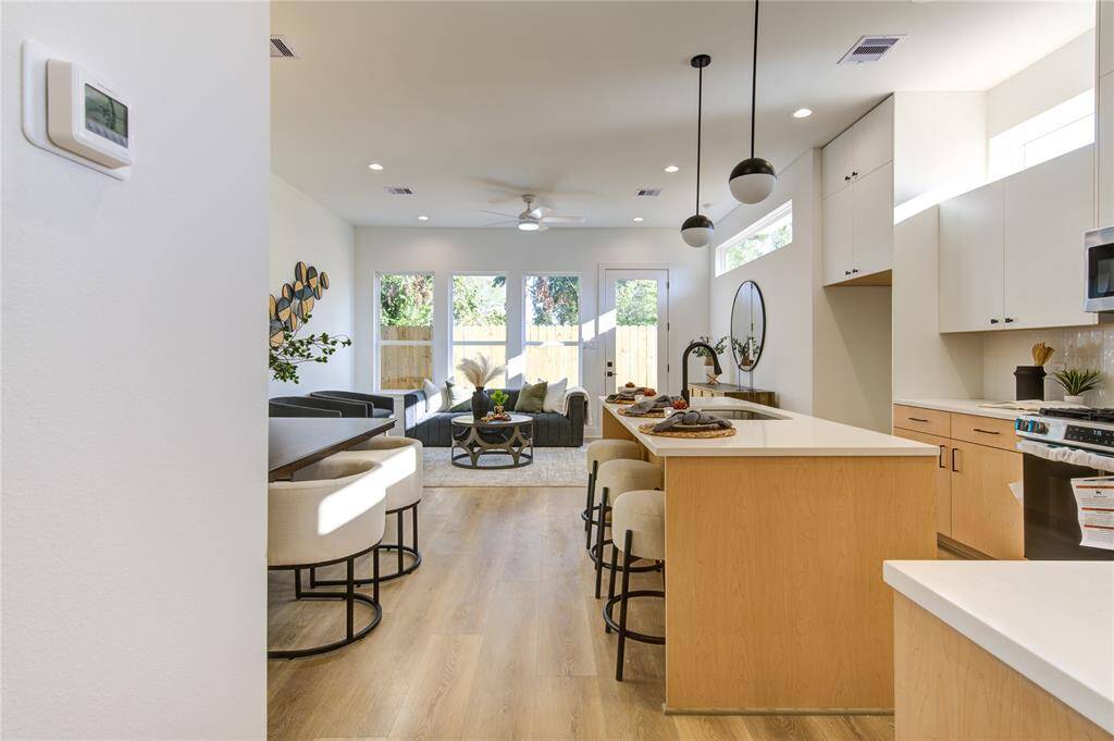First floor open concept living with modern cabinetry, and all stainless steel appliances are included
