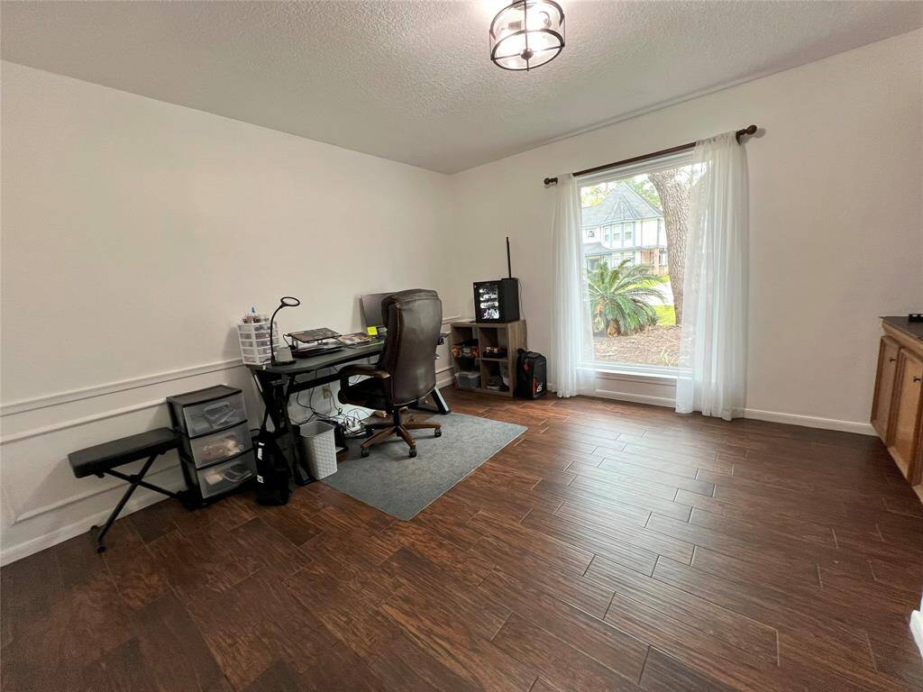 Oversized formal dining being used as an office.