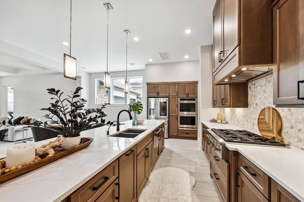 Large island with pendant lighting and an open view to the living area, creating a perfect space for entertaining.