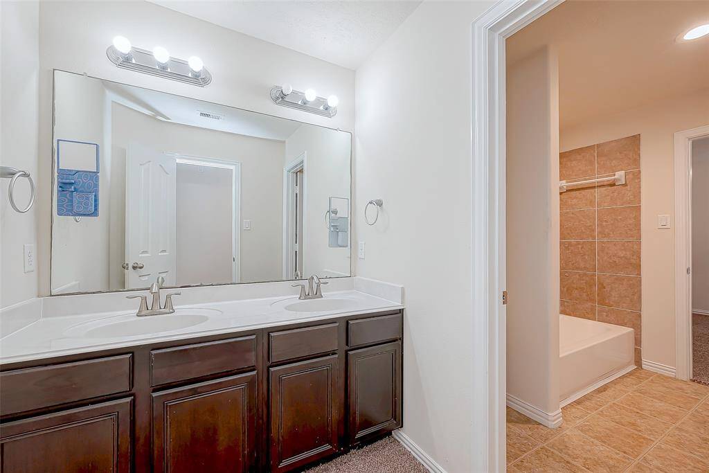 Secondary bath has two sinks.